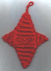Photo of a knitted 4-pointed star Xmas ornament